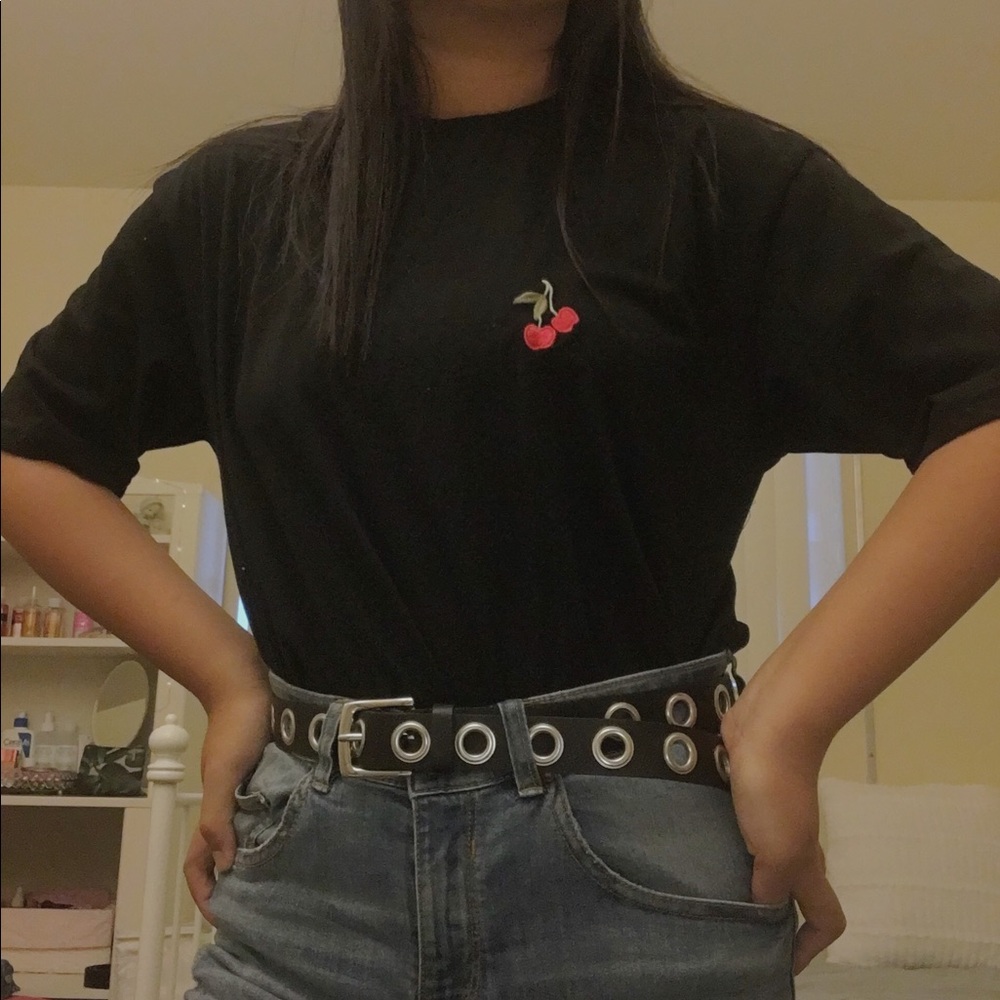 A black tee shirt with a cherry embroidered